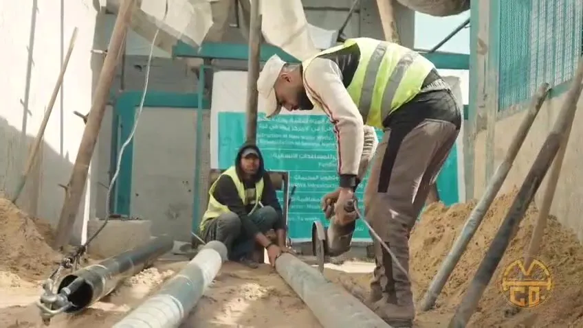 UNRWA water rehabilitation — M&H team with UNRWA project sign